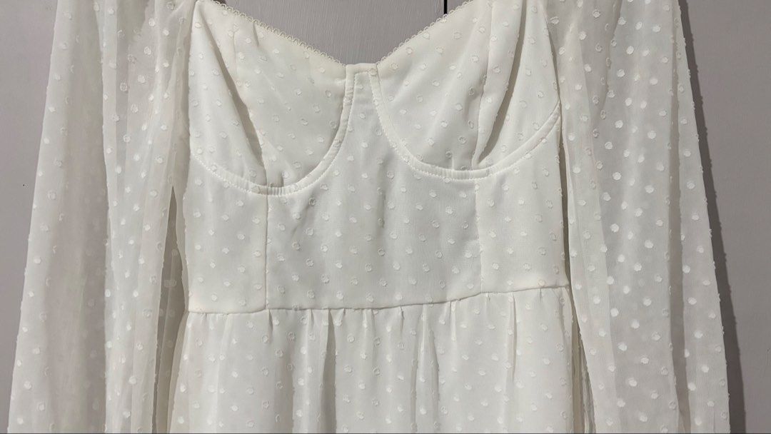 White Swiss Dot Long Sleeve Mini Dress (Category: Dresses) located in Batangas. Submitted by rm0401 (Listing ID 1470350093, Image 3). Description: - Color: White with all-over Swiss dot pattern - Fit & Style: Structured sweetheart bustier bodice and flowy A-line skirt - Sleeves: Long sheer sleeves with comfortable elastic cuffs - Details: Fully lined skirt, easy back zipper closure - Occasion: Ideal for dates, brunch, or casual day outs size: s-m