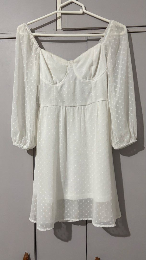 White Swiss Dot Long Sleeve Mini Dress (Category: Dresses) located in Batangas. Submitted by rm0401 (Listing ID 1470350093, Image 2). Description: - Color: White with all-over Swiss dot pattern - Fit & Style: Structured sweetheart bustier bodice and flowy A-line skirt - Sleeves: Long sheer sleeves with comfortable elastic cuffs - Details: Fully lined skirt, easy back zipper closure - Occasion: Ideal for dates, brunch, or casual day outs size: s-m