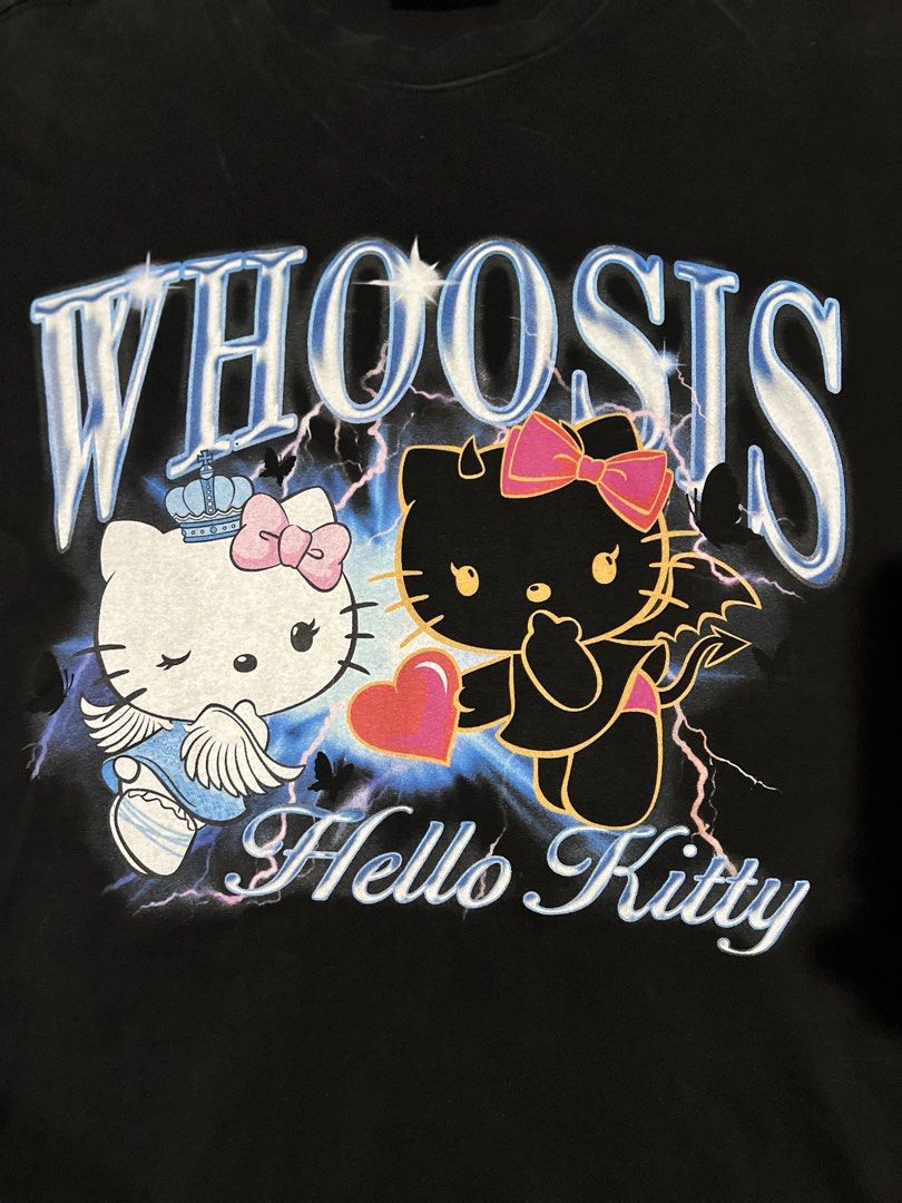 Whoosis x Hello Kitty Black Graphic Tee (Category: Shirts) located in San Carlos. Submitted by binaryapparelco (Listing ID 1470485474, Image 2). Description: - Brand: Whoosis x Kitty (Official Sanrio 2023 collaboration) - Color: Black - Size: M (170/88A), relaxed short-sleeve cut with standard crew neck - Design: Front graphic with Kitty characters, lightning/star details, and 'Whoosis' lettering 📌 Dimes:W- 22.5/ L- 28.5 📌 Color rate: 9.2/10 📌