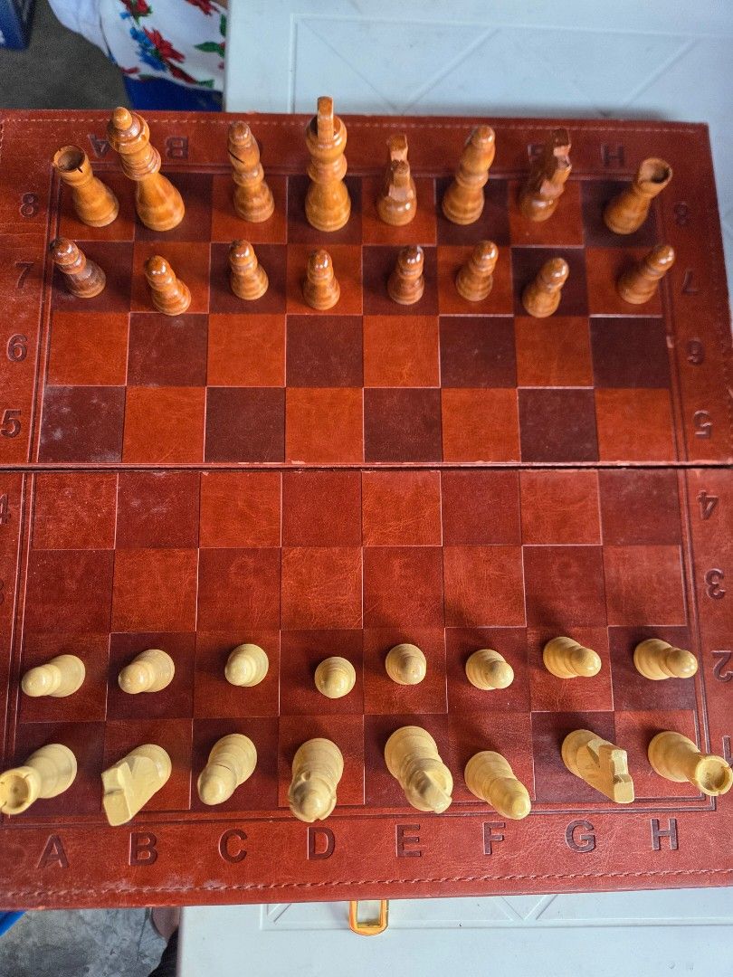 Wooden Foldable Chess and Backgammon Board Game Set (Category: Board Games & Puzzles) located in Consolacion. Submitted by itsybitsywins (Listing ID 1470449185, Image 3). Description: - 2-in-1 Board Game: Includes both chess and backgammon in one portable set. - Premium Design: Wooden folding board with a sleek leather-style finish. - Complete Set: Comes with all standard chess and backgammon playing pieces. - Travel-Friendly: Board folds in half