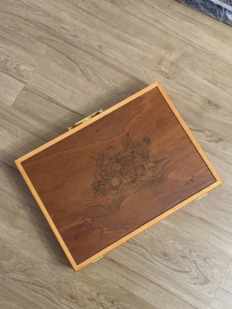 Wooden Mahjong Set With Storage Case (Category: Board Games & Puzzles) located in Valenzuela. Submitted by allgoodstyo (Listing ID 1470351139, Image 1). Description: - Complete mahjong set with wooden tiles, counting chips, dice, and spare tiles - Housed in a sturdy wooden carrying case with brass-toned latches and hinges - Lid features detailed engraved artwork of figures in a landscape with Chinese characters - Clean wooden surfaces throughout 