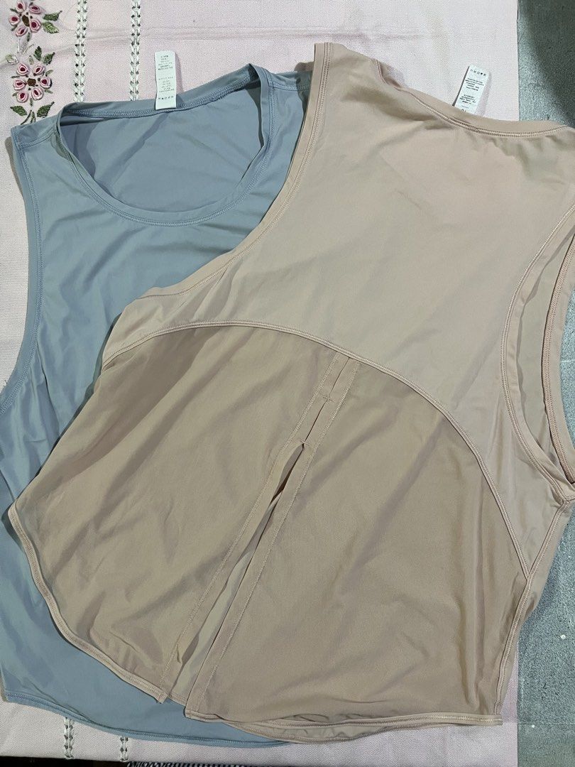 Workout Tank Tops blue and peach (Category: Sleeveless) located in Marikina City. Submitted by tintinarenas (Listing ID 1470464665, Image 3). Description: - Quantity: Set of 2 tank tops - Size: 10 (Tags attached) - Fit & Style: Scoop neckline, sleeveless, curved hem with split back detail - Performance: Lightweight, stretchy, and quick-dry fabric .