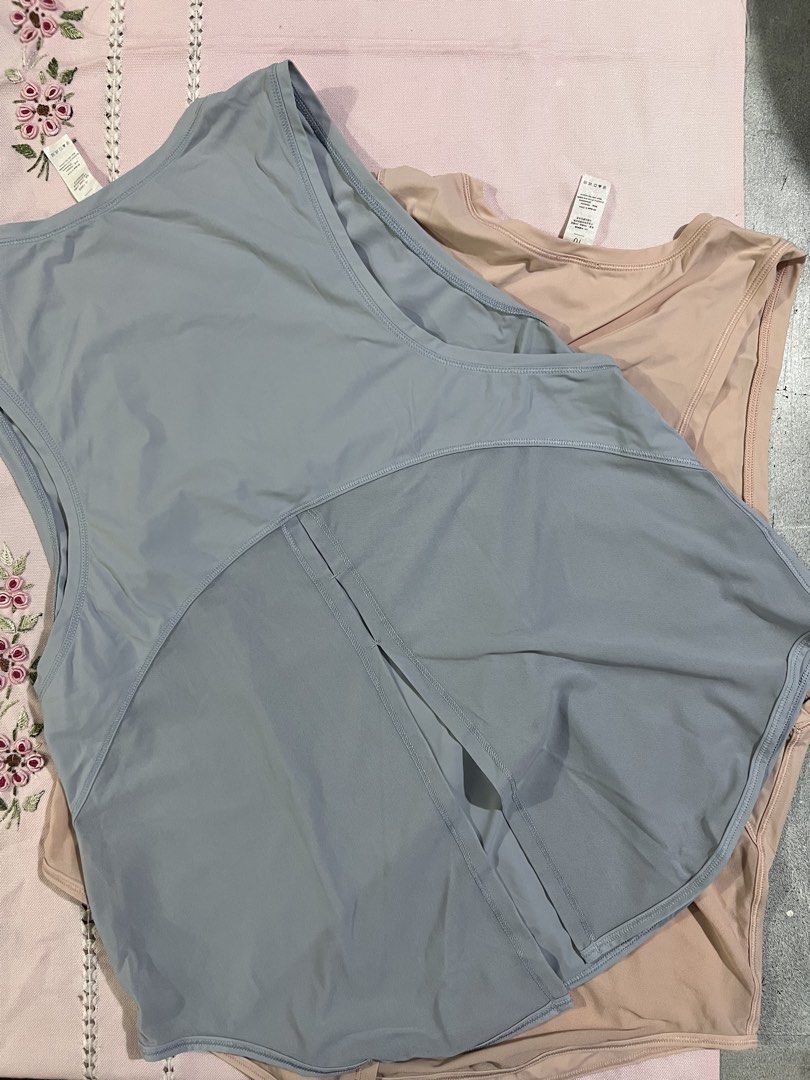 Workout Tank Tops blue and peach (Category: Sleeveless) located in Marikina City. Submitted by tintinarenas (Listing ID 1470464665, Image 1). Description: - Quantity: Set of 2 tank tops - Size: 10 (Tags attached) - Fit & Style: Scoop neckline, sleeveless, curved hem with split back detail - Performance: Lightweight, stretchy, and quick-dry fabric .
