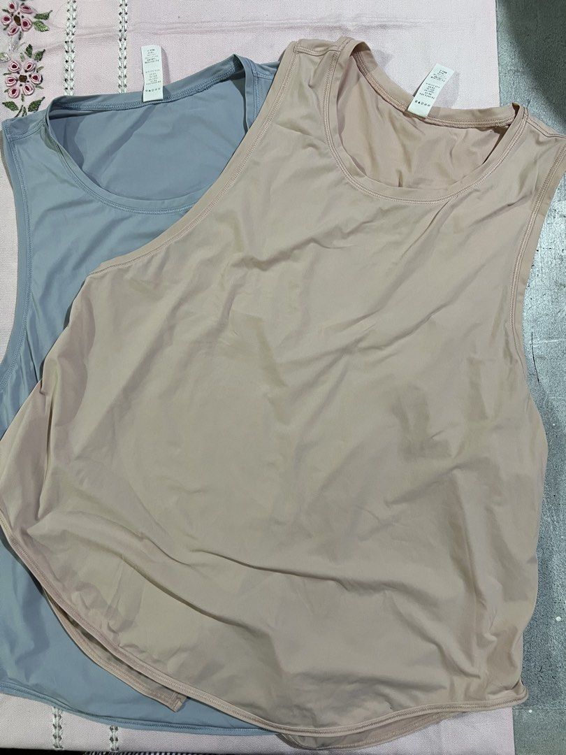 Workout Tank Tops blue and peach (Category: Sleeveless) located in Marikina City. Submitted by tintinarenas (Listing ID 1470464665, Image 2). Description: - Quantity: Set of 2 tank tops - Size: 10 (Tags attached) - Fit & Style: Scoop neckline, sleeveless, curved hem with split back detail - Performance: Lightweight, stretchy, and quick-dry fabric .