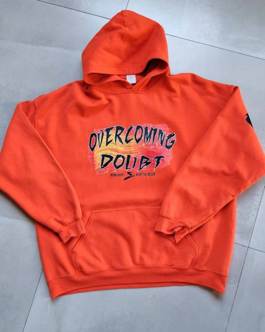Worn Skript Overcoming Doubt Orange Hoodie (Category: Coats, Jackets and Outerwear) located in Bauang. Submitted by wornskript (Listing ID 1470480287, Image 2). Description: Orange Gildan Heavyweight Oversized Hoodie Size : XL Dimes : 26" x 37" - Color: Bright orange - Material: Heavyweight fleece (super cozy) - Design: "Overcoming Doubt" front graphic with artsy red/yellow paint stroke background and "wear the unsaid" text - Back Details: Bold "
