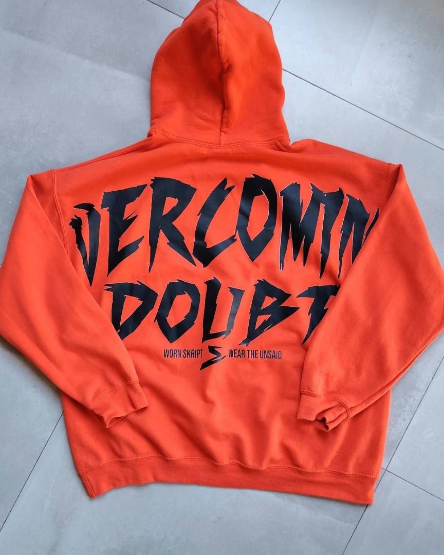 Worn Skript Overcoming Doubt Orange Hoodie (Category: Coats, Jackets and Outerwear) located in Bauang. Submitted by wornskript (Listing ID 1470480287, Image 3). Description: Orange Gildan Heavyweight Oversized Hoodie Size : XL Dimes : 26" x 37" - Color: Bright orange - Material: Heavyweight fleece (super cozy) - Design: "Overcoming Doubt" front graphic with artsy red/yellow paint stroke background and "wear the unsaid" text - Back Details: Bold "