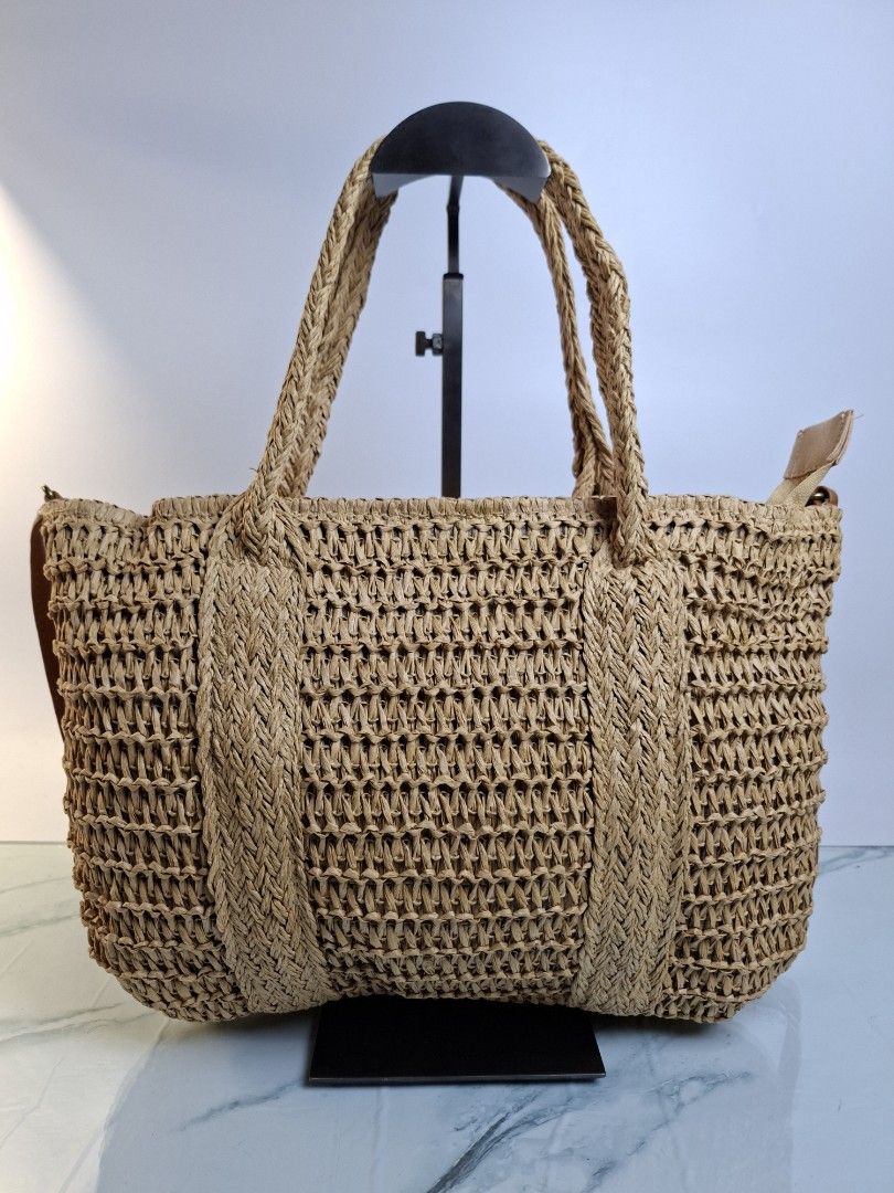 Woven Straw Handbag with Tassel and Brown Straps Bundle (Category: Shoulder Bags) located in Pasay City. Submitted by onick_79 (Listing ID 1470415655, Image 3). Description: - Stylish tan woven straw design with an open weave texture - Features brown faux leather shoulder straps and top handles - Cute side tassel pendant accented with wooden beads - Secure top zipper closure to keep your belongings safe - Lightweight and ideal for summer outings,
