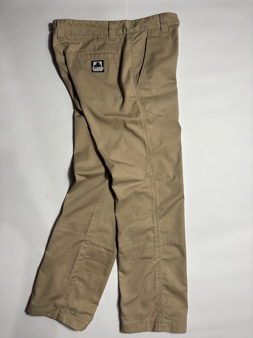 Xlarge Beige Work Pants (Category: Trousers) located in San Fernando. Submitted by lumang_gamit (Listing ID 1470396961, Image 1). Description: - Brand: XLARGE - Color: Tan - Style: Classic streetwear work pants - Details: Woven logo patch on back pocket - Special Feature: Cool colorful branded print lining inside waistband and cuffs (great for rolling up) - Condition/Fabric: Solid everyday trousers made with sturdy fabric.