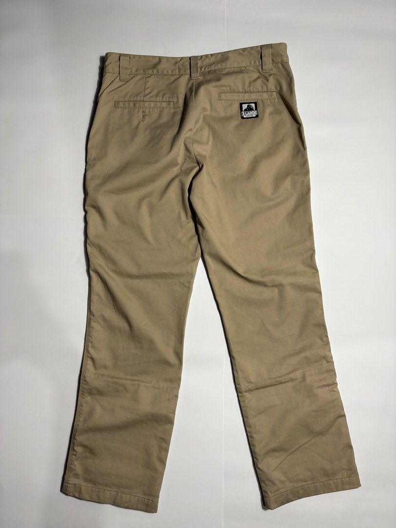 Xlarge Beige Work Pants (Category: Trousers) located in San Fernando. Submitted by lumang_gamit (Listing ID 1470396961, Image 2). Description: - Brand: XLARGE - Color: Tan - Style: Classic streetwear work pants - Details: Woven logo patch on back pocket - Special Feature: Cool colorful branded print lining inside waistband and cuffs (great for rolling up) - Condition/Fabric: Solid everyday trousers made with sturdy fabric.