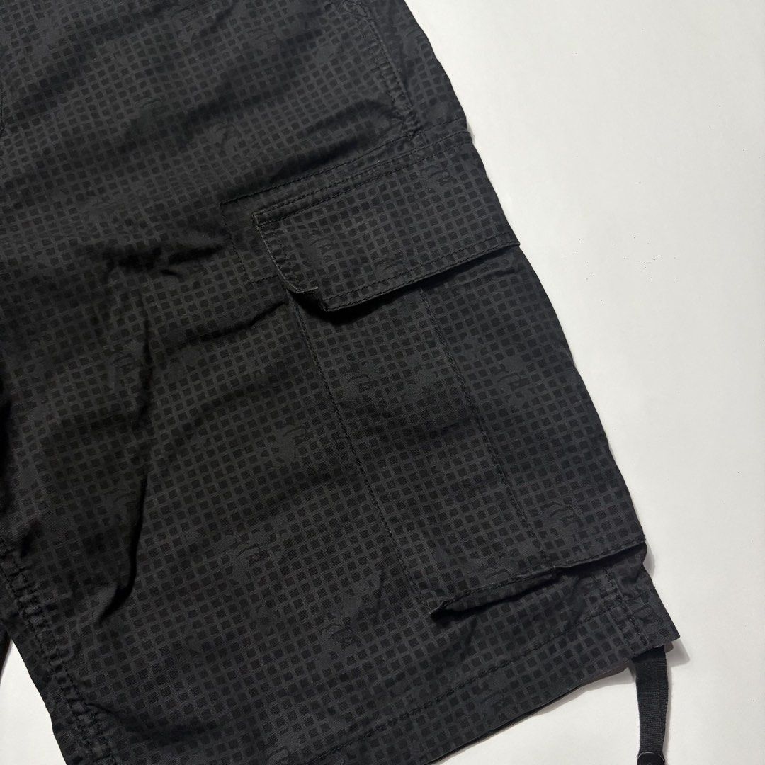 Xlarge Black Cargo Shorts Size 32 (Category: Shorts) located in San Fernando. Submitted by lumang_gamit (Listing ID 1470398337, Image 3). Description: - Size: 32 waist (Xlarge fit) - Color/Pattern: Black grid pattern - Fit & Adjustability: Side adjustment buckles at the waistband and drawstring leg openings - Storage: Multiple utility pockets with secure button flaps - Details: Features woven brand labels on the inside and back pocket.