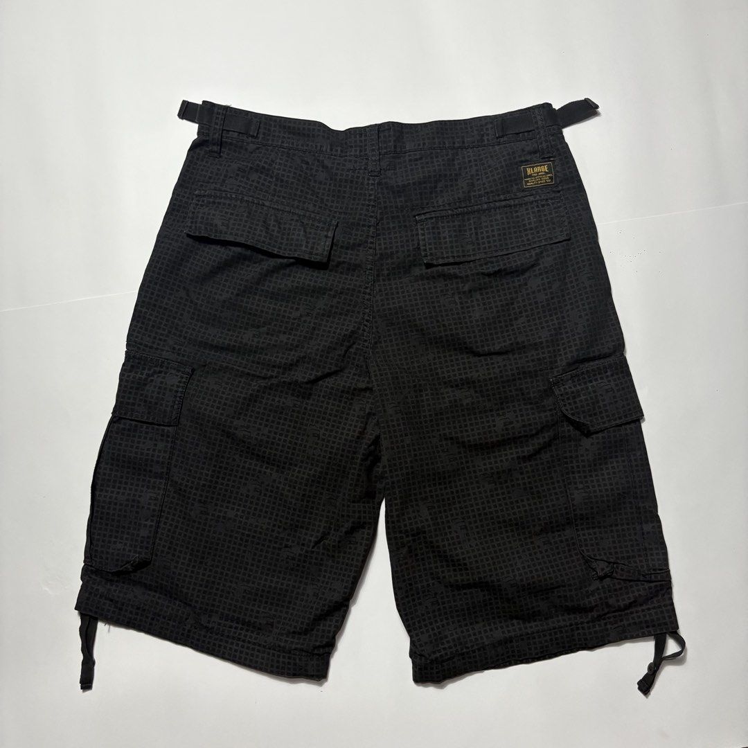 Xlarge Black Cargo Shorts Size 32 (Category: Shorts) located in San Fernando. Submitted by lumang_gamit (Listing ID 1470398337, Image 2). Description: - Size: 32 waist (Xlarge fit) - Color/Pattern: Black grid pattern - Fit & Adjustability: Side adjustment buckles at the waistband and drawstring leg openings - Storage: Multiple utility pockets with secure button flaps - Details: Features woven brand labels on the inside and back pocket.