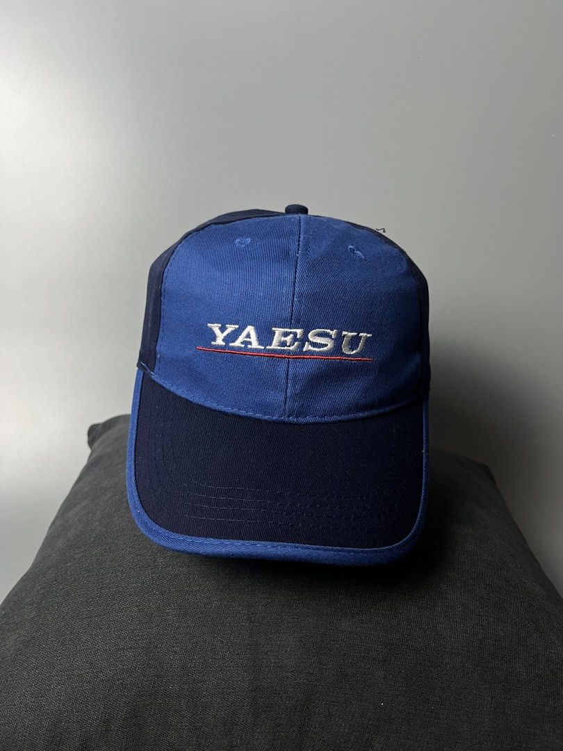 YAESU System Fusion Hat Cap Blue (Category: Caps & Hats) located in Dagupan City. Submitted by loves2thrifth (Listing ID 1470369332, Image 1). Description: - Authentic YAESU baseball cap in blue and dark navy - Embroidered YAESU logo on the front - System Fusion branding embroidered on the back - Adjustable strap closure for a custom fit - Structured front panels with eyelets for ventilation - Clean condition inside and out - Great find for ham r