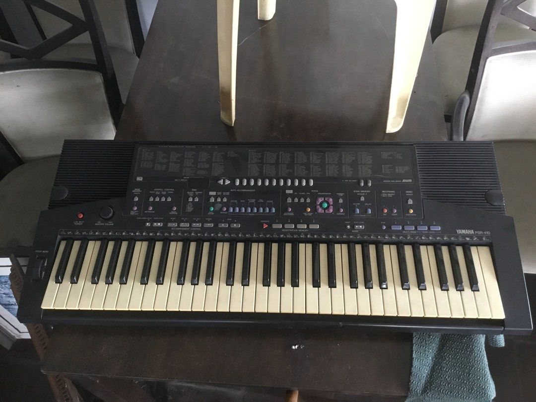 Yamaha PSR-410 Electronic Keyboard (Category: Musical Instruments) located in Manila. Submitted by roberto.enriquez (Listing ID 1470556635, Image 2). Description: - Model: Yamaha PSR-410 Portable Keyboard (Black) - Condition: Good working condition with minor yellowing on keys due to age - Features: Built-in voices, auto accompaniment, registration memory, and pitch bend wheel - Audio: Built-in stereo speakers - Power: Standard power adapter incl