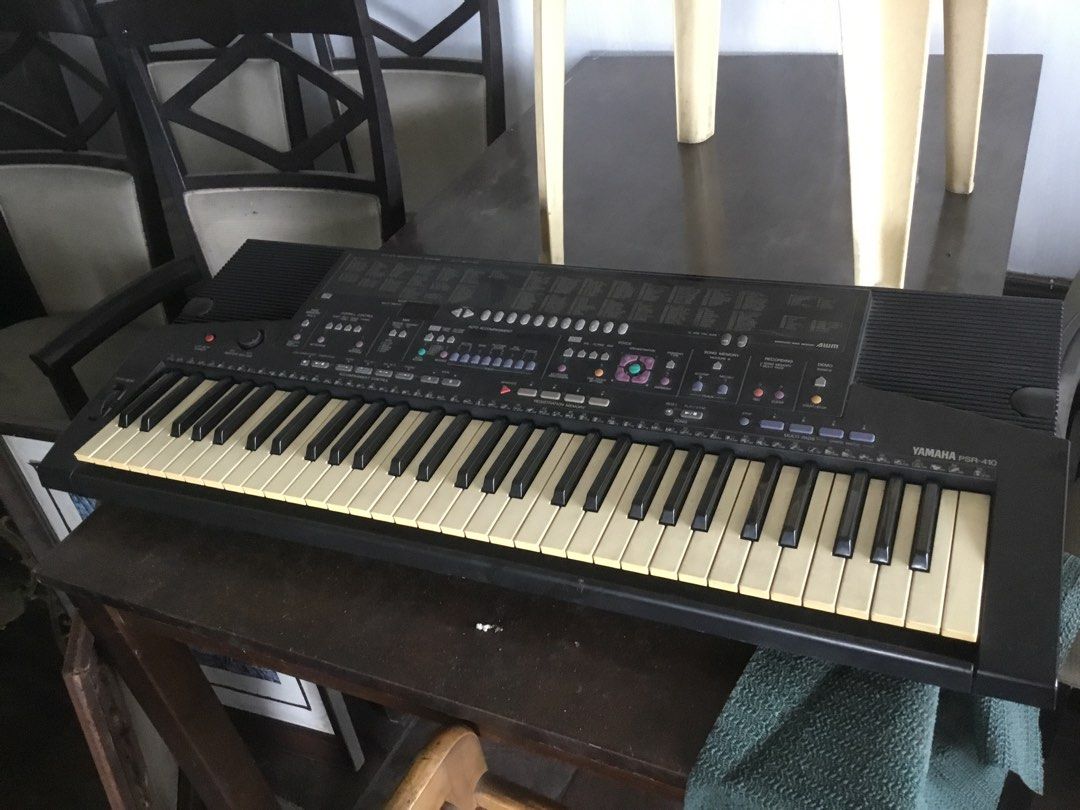 Yamaha PSR-410 Electronic Keyboard (Category: Musical Instruments) located in Manila. Submitted by roberto.enriquez (Listing ID 1470556635, Image 3). Description: - Model: Yamaha PSR-410 Portable Keyboard (Black) - Condition: Good working condition with minor yellowing on keys due to age - Features: Built-in voices, auto accompaniment, registration memory, and pitch bend wheel - Audio: Built-in stereo speakers - Power: Standard power adapter incl