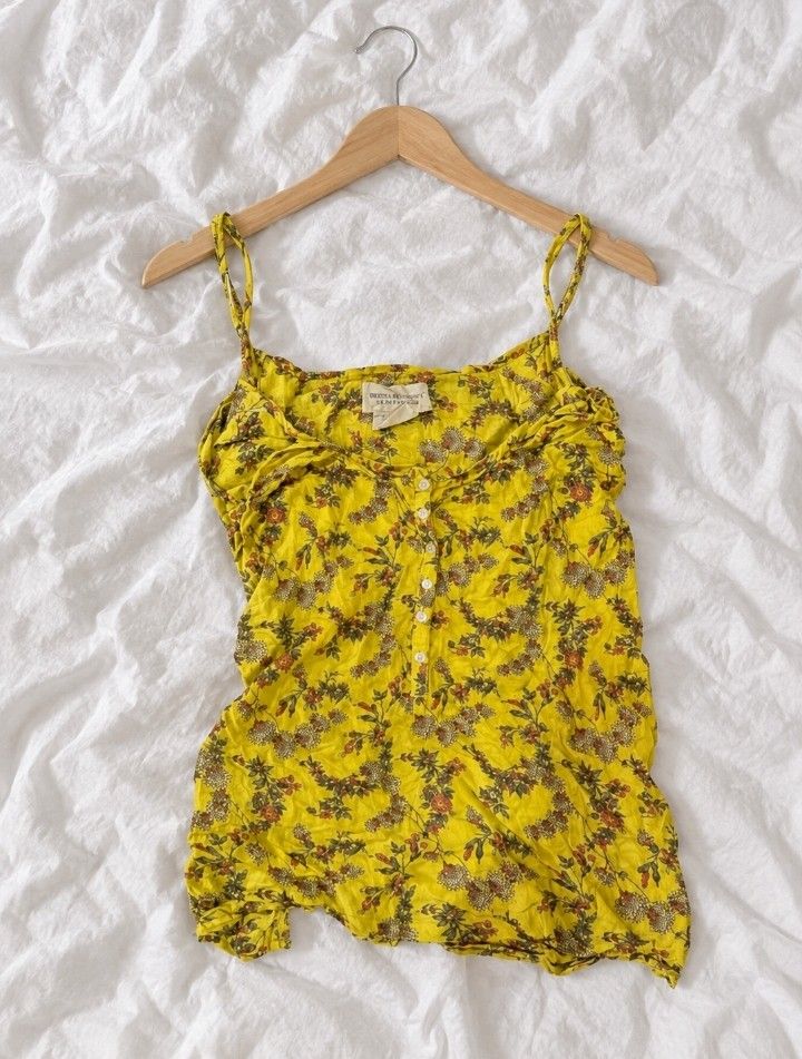 Yellow Floral Button-Down Cami Top 💓🪽 (Category: Sleeveless) located in Batangas. Submitted by itgirl.archive (Listing ID 1470372343, Image 1). Description: Brand: Denim & Supply Ralph Lauren Size: Small to Medium Color: Mustard yellow with multicolor floral prints Material: Lightweight, breathable-looking fabric Design: Spaghetti straps, sweetheart neckline, ruched bust, and white front buttons Style: Vintage, cottagecore, boho, Y2K Condition: