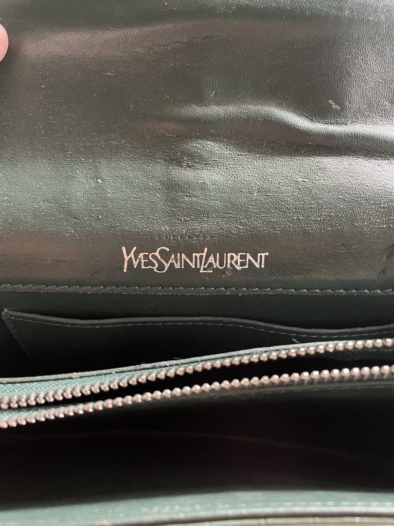 YSL - SAINT LAURENT CASSANDRA (Category: Luxury Bags & Wallets) located in Cagayan de Oro. Submitted by jericc1 (Listing ID 1470490770, Image 2). Description: - Brand: Yves Saint Laurent (YSL) - Model: Cassandra Handbag - Color: Dark Green with Croc-Embossed Finish - Hardware: Silver-tone with signature YSL interlocking logo - Strap: Chain strap with leather shoulder guard - Condition: 7/10 (shows minor wear/flaw on the strap as seen in photos) -