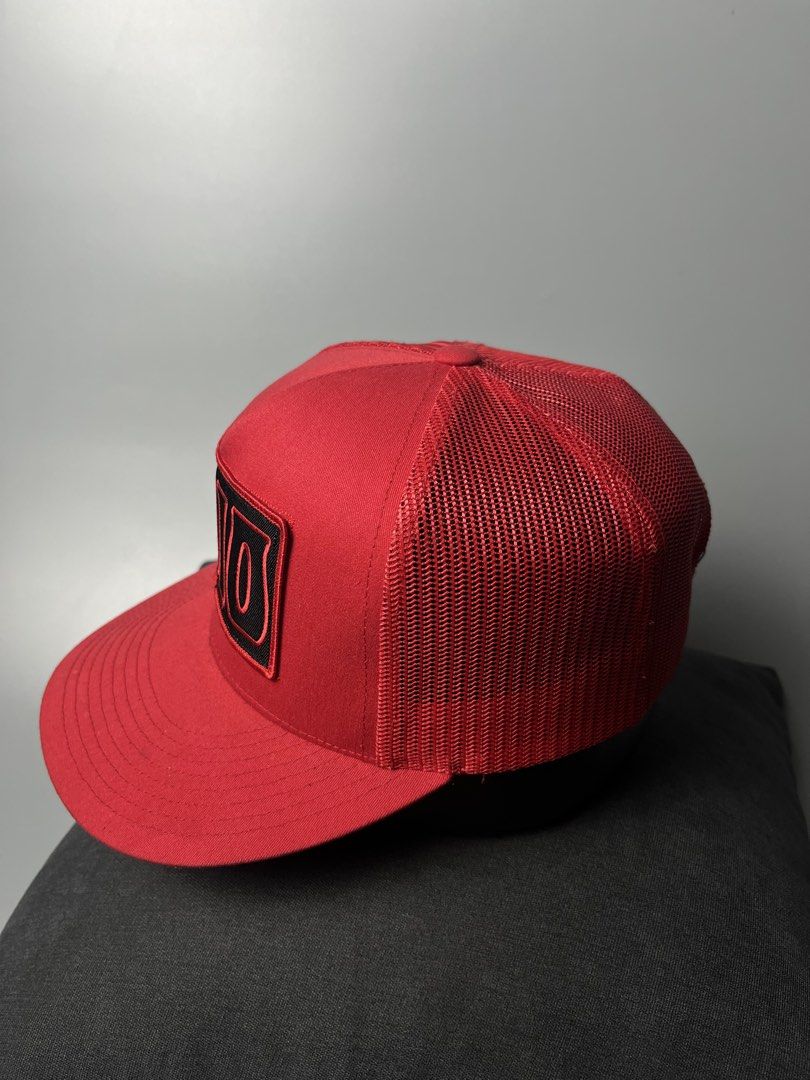 Yupoong The Classics 1910 Trucker Hat Red Snapback (Category: Caps & Hats) located in Dagupan City. Submitted by loves2thrifth (Listing ID 1470369452, Image 3). Description: - Brand: Yupoong The Classics - Style: Trucker hat with structured front panels and breathable mesh back - Design: Embroidered black and red '1910' patch on the front crown - Color: Vibrant red with matching red adjustable plastic snapback closure - Condition: Clean all aroun
