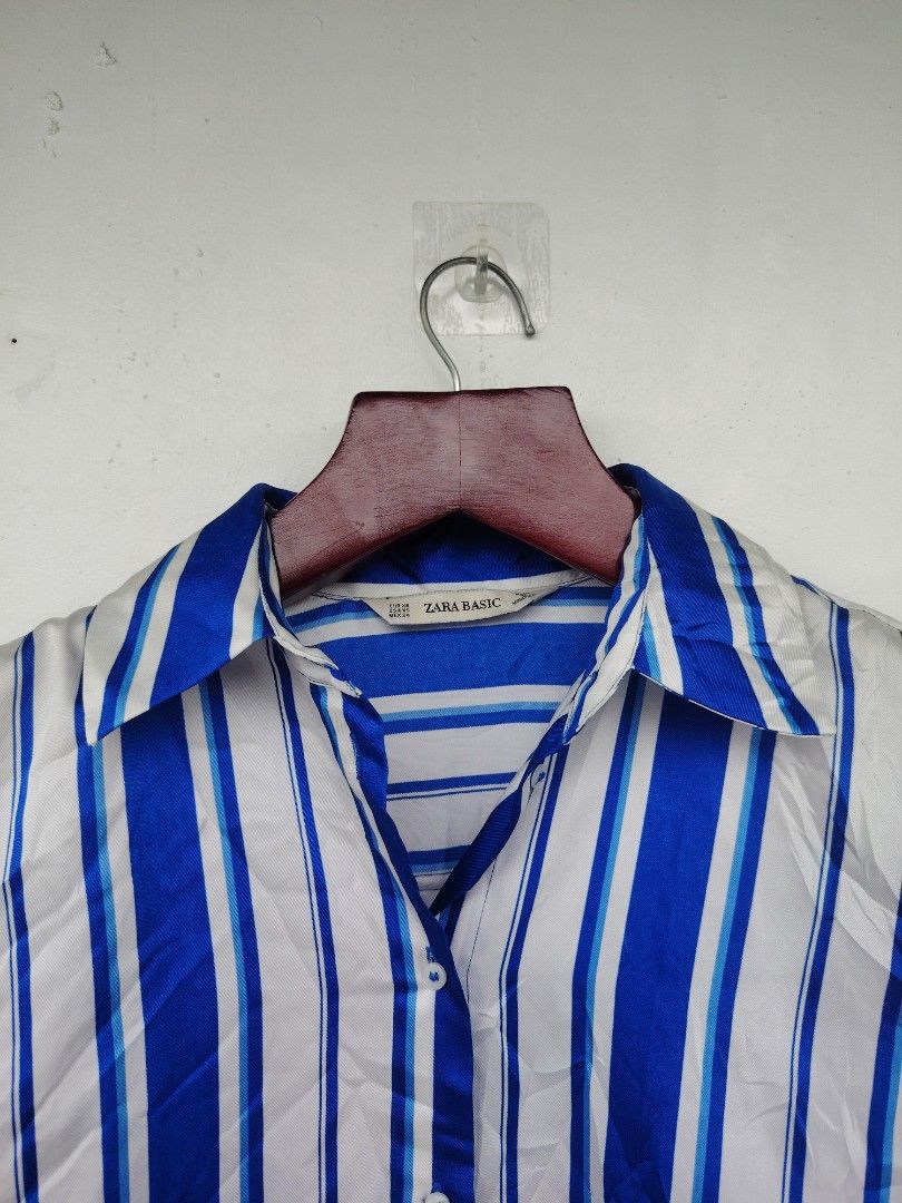 ​Zara Basic Blue & White Striped Long Sleeve Satin-Finish Blouse | Size XS (Category: Others Tops) located in Pandi. Submitted by thriftcircuit (Listing ID 1470452219, Image 2). Description: Zara Basic Vertical Striped Button-Down Blouse ​💙 Elegant and versatile Zara Basic long-sleeve button-up blouse featuring vibrant royal blue and white vertical stripes. Silky, satin-like finish with a high-low asymmetrical hem that looks great tucked in or s