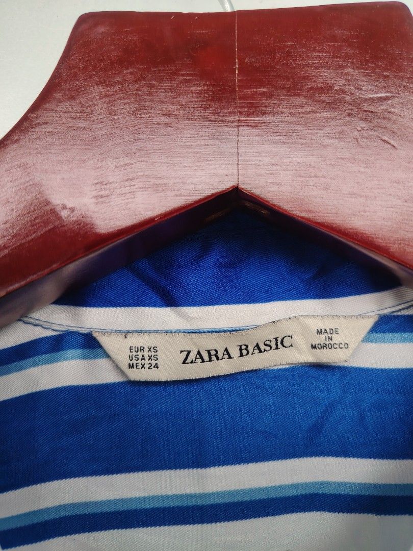 ​Zara Basic Blue & White Striped Long Sleeve Satin-Finish Blouse | Size XS (Category: Others Tops) located in Pandi. Submitted by thriftcircuit (Listing ID 1470452219, Image 3). Description: Zara Basic Vertical Striped Button-Down Blouse ​💙 Elegant and versatile Zara Basic long-sleeve button-up blouse featuring vibrant royal blue and white vertical stripes. Silky, satin-like finish with a high-low asymmetrical hem that looks great tucked in or s
