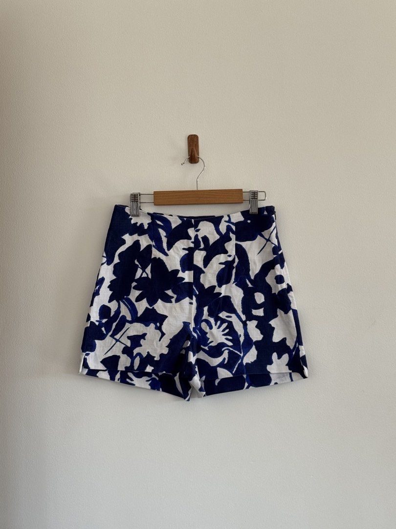 Zara Basic Blue and White Floral Shorts (Category: Shorts) located in Rizal. Submitted by mharieshine (Listing ID 1470451934, Image 1). Description: Zara Basic shorts, blue and white floral print. Made in Spain. Size EUR XS. Structured waist design, clean finish. Includes a second pair of white shorts with blue embroidered hem and drawstring waist. Great bundle for summer. Both items clean, well-maintained..