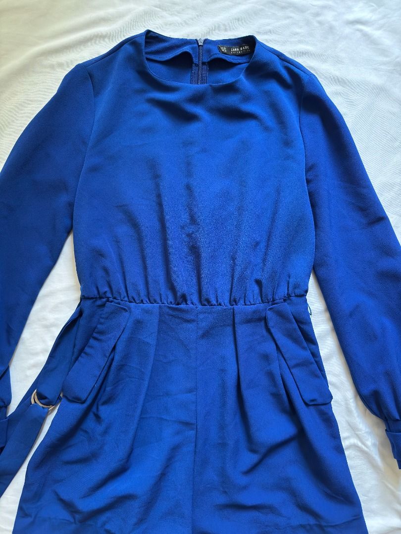 Zara Basic Blue Long Sleeve Romper Size XS (Category: Rompers) located in Cebu City. Submitted by _t.rix (Listing ID 1470372971, Image 3). Description: - Brand: Zara Basic - Size: XS - Color: Vibrant royal blue - Features: Long sleeves with cuffs, back zipper closure, front flap pockets - Includes: Matching waist belt with ring detail - Material: Lightweight and comfortable - Condition: Great for casual outings or night events.