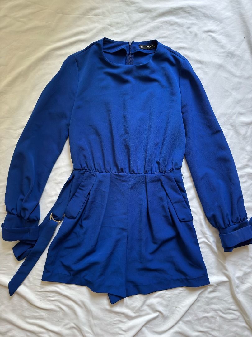Zara Basic Blue Long Sleeve Romper Size XS (Category: Rompers) located in Cebu City. Submitted by _t.rix (Listing ID 1470372971, Image 2). Description: - Brand: Zara Basic - Size: XS - Color: Vibrant royal blue - Features: Long sleeves with cuffs, back zipper closure, front flap pockets - Includes: Matching waist belt with ring detail - Material: Lightweight and comfortable - Condition: Great for casual outings or night events.