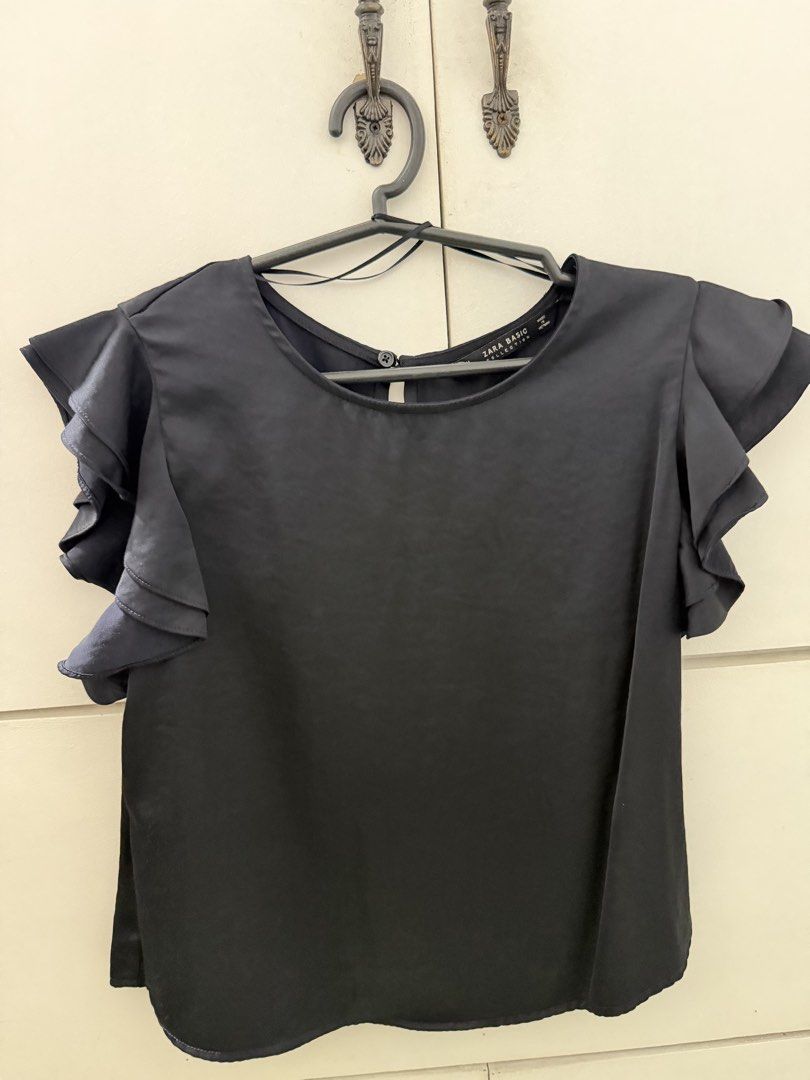 Zara Basic Collection Black Ruffle Sleeve Blouse (Category: Blouses) located in Manila. Submitted by mnlclaudia (Listing ID 1470510636, Image 1). Description: - Brand/Model: Zara Basic - Color: Black - Size: M - Design: Layered ruffle sleeves, rounded neckline, back button closure with keyhole cutout - Material: Smooth, lightweight fabric - Origin: Made in Vietnam.