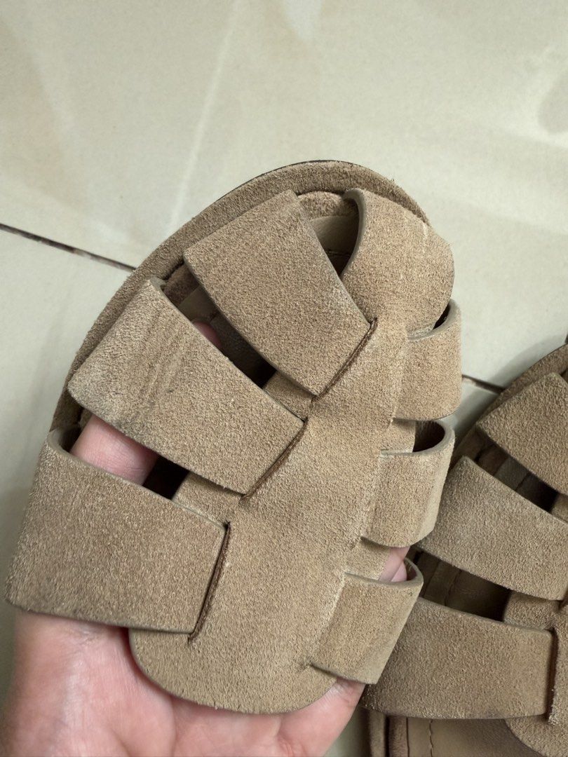 ZARA Beige Suede Flat Sandals Size 37 (Category: Flats & Sandals) located in Makati City. Submitted by andzr. (Listing ID 1470425584, Image 3). Description: ZARA beige suede sandals in size 37. Flat style with woven strap design across the top. Adjustable ankle strap with gold-tone buckle. Soles show light signs of wear from walking. Soft material, comfortable fit for daily outfit pairings..