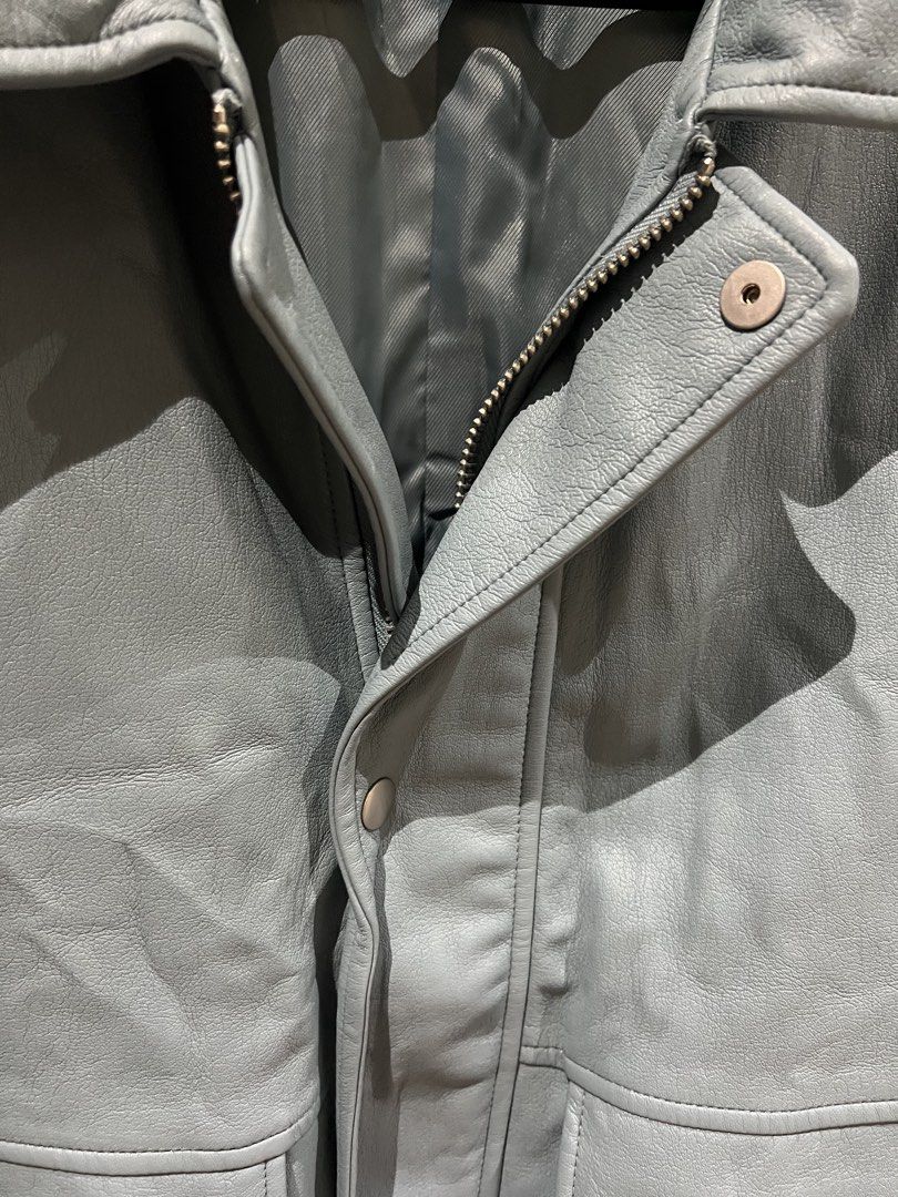 Zara Blue Grey Leather Jacket with Front Pockets (Category: Coats, Jackets and Outerwear) located in Quezon City. Submitted by Zandee (Listing ID 1470486877, Image 3). Description: - Color: Blue-grey - Material: Soft textured leather with a lined interior - Closure: Full zip and snap button closure - Pockets: Two large front flap pockets on the chest - Fit: Adjustable drawstring hem at the waist - Style: Collared neck.