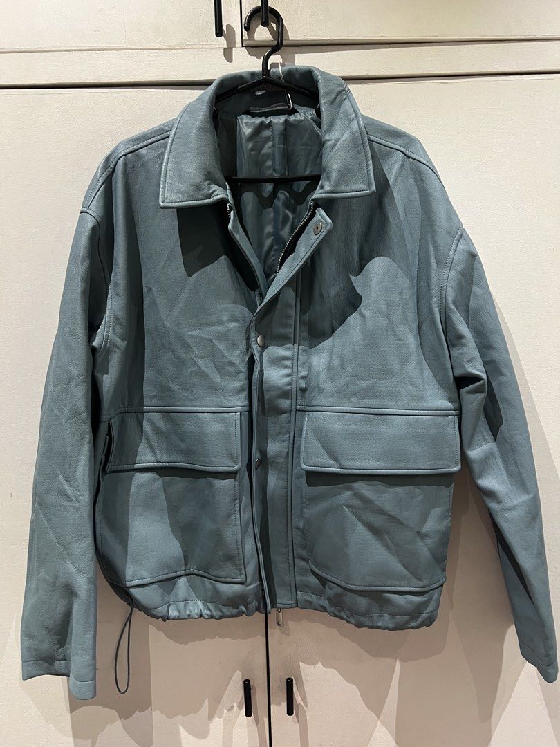 Zara Blue Grey Leather Jacket with Front Pockets (Category: Coats, Jackets and Outerwear) located in Quezon City. Submitted by Zandee (Listing ID 1470486877, Image 1). Description: - Color: Blue-grey - Material: Soft textured leather with a lined interior - Closure: Full zip and snap button closure - Pockets: Two large front flap pockets on the chest - Fit: Adjustable drawstring hem at the waist - Style: Collared neck.