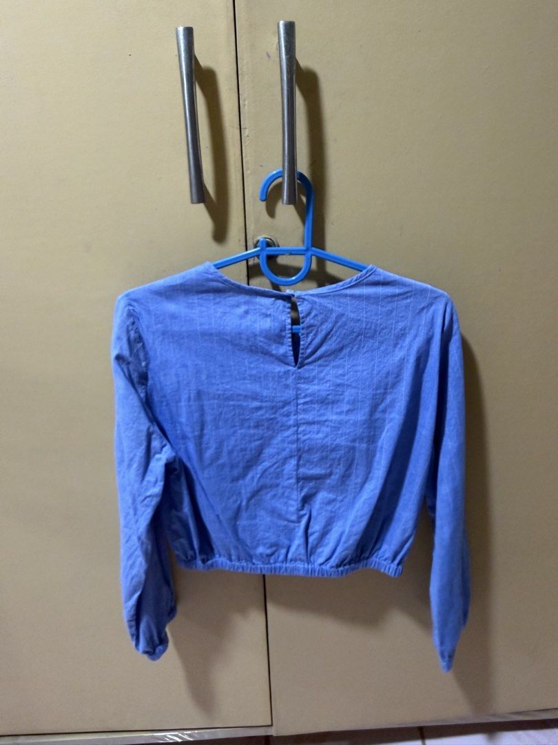 Zara Blue Ruched Crop Blouse (Category: Blouses) located in Quezon City. Submitted by delideclutters (Listing ID 1470538851, Image 2). Description: - Brand: Zara - Size: 13-14 years (164 cm) - Color: Light blue with subtle vertical pinstripes - Design: Crop blouse with long sleeves and back neckline button closure - Details: Adjustable front ruching with drawstrings, plus elastic hem and cuffs for a comfortable fit - Condition: Great pre-loved co