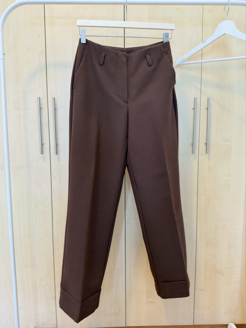 Zara Brown Cuffed Tailored Trousers (Category: Other Bottoms) located in Makati City. Submitted by itsmeann09 (Listing ID 1470392069, Image 1). Description: - Brand/Model: Zara brown trousers - Size: XS - Fit: High-waisted with belt loops, front zip fly, and button closure - Cut: Straight leg with stylish folded cuffs at the hem - Pockets: Two back welt pockets - Style/Color: Rich chocolate brown, versatile for office wear or casual outings.