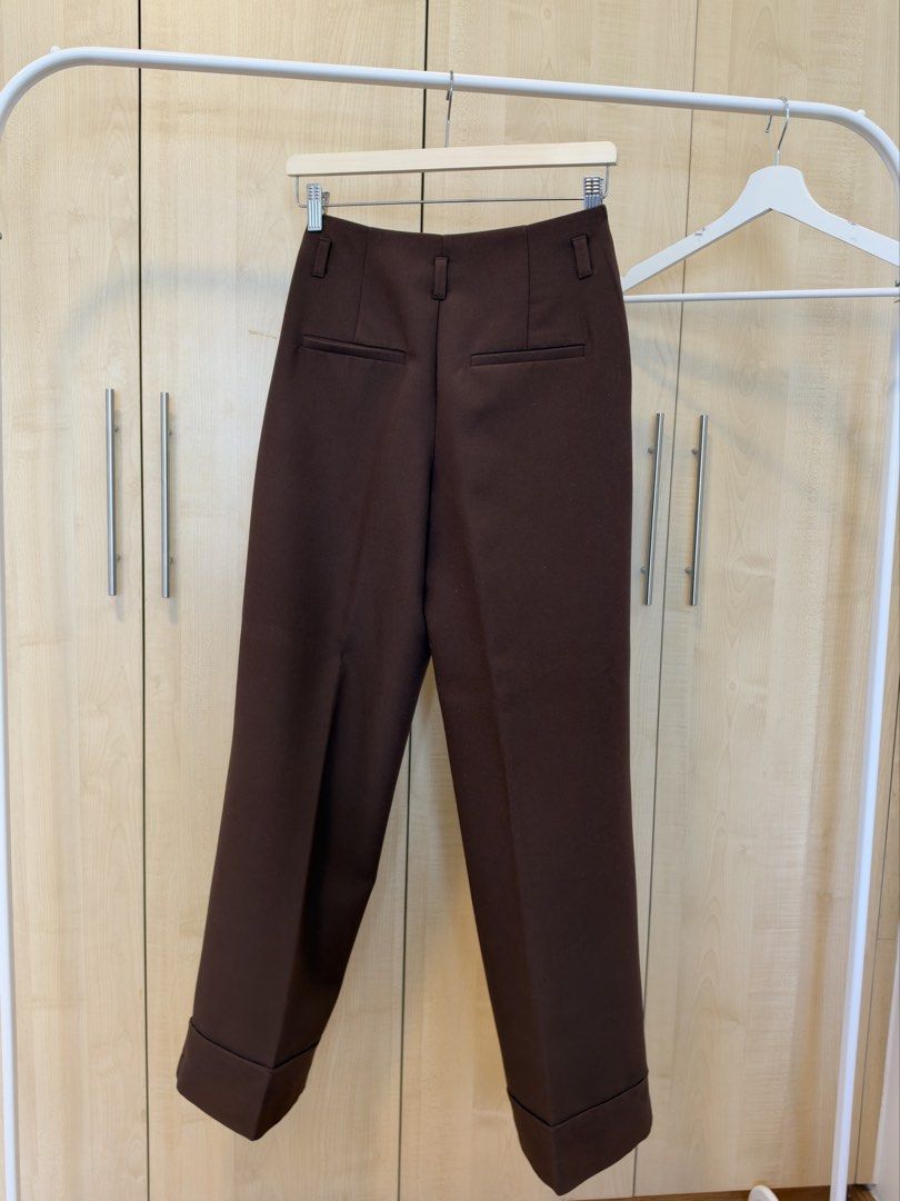 Zara Brown Cuffed Tailored Trousers (Category: Other Bottoms) located in Makati City. Submitted by itsmeann09 (Listing ID 1470392069, Image 3). Description: - Brand/Model: Zara brown trousers - Size: XS - Fit: High-waisted with belt loops, front zip fly, and button closure - Cut: Straight leg with stylish folded cuffs at the hem - Pockets: Two back welt pockets - Style/Color: Rich chocolate brown, versatile for office wear or casual outings.