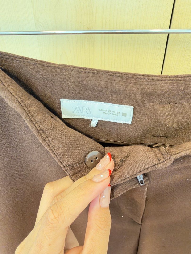 Zara Brown Cuffed Tailored Trousers (Category: Other Bottoms) located in Makati City. Submitted by itsmeann09 (Listing ID 1470392069, Image 2). Description: - Brand/Model: Zara brown trousers - Size: XS - Fit: High-waisted with belt loops, front zip fly, and button closure - Cut: Straight leg with stylish folded cuffs at the hem - Pockets: Two back welt pockets - Style/Color: Rich chocolate brown, versatile for office wear or casual outings.