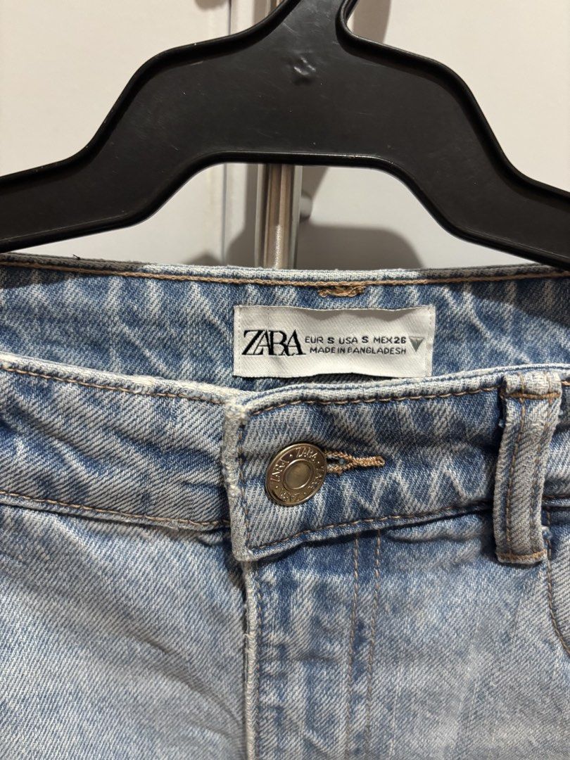 Zara Denim Midi Skirt Size (Category: Skirts) located in Manila. Submitted by grandwhale.e87eca (Listing ID 1470398644, Image 2). Description: - Brand: Zara - Style: Mid-length light wash denim skirt with front slit - Details: Classic 5-pocket design, belt loops, metal button, and zip fly - Size: S (EUR S, USA S, MEX 26) - Origin: Made in Bangladesh - Condition: Great for casual weekend styling with tees or blouses.