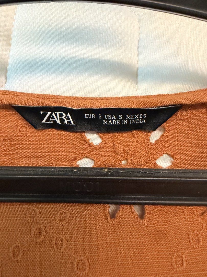 Zara Orange Eyelet Embroidered Wrap Blouse Size S (Category: Blouses) located in Calamba. Submitted by xnikkidg (Listing ID 1470451092, Image 2). Description: - Brand: Zara - Size: S (EUR/USA/MEX) - Color: Orange - Material: Textured weave with all-over eyelet embroidery - Design: Wrap style front with 2 buttons near the hem, short puff sleeves, and elasticated waist - Origin: Made in India.