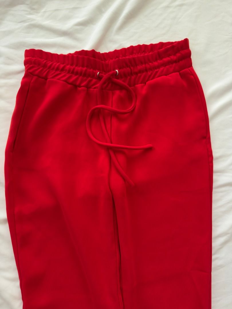 Zara TRF Red Joggers Drawstring Sweatpants Size XS (Category: Joggers) located in Cebu City. Submitted by _t.rix (Listing ID 1470382596, Image 1). Description: - Brand: Zara TRF - Size: Extra Small (XS) - Color: Bright Red - Fit: High waist with adjustable drawstring and comfortable elasticated ankle cuffs - Material: Soft and cozy fabric - Best for: Casual outfits, running errands, or lounging at home.