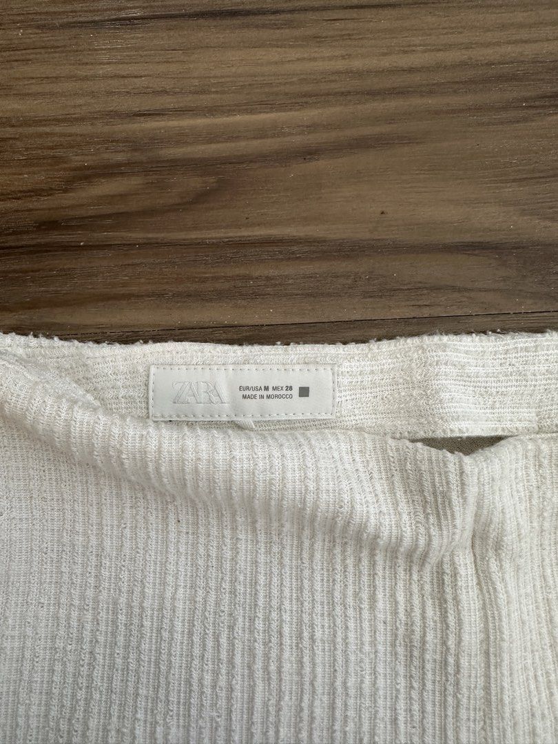 Zara White Knit Ruffle Hem Pants Size M (Category: Jeans) located in Paranaque City. Submitted by declutterwyae (Listing ID 1470391559, Image 3). Description: - Brand: Zara - Style: Knit pants with cute ruffled hems - Color: Off-white - Size: M (EUR/USA M, MEX 28) - Details: Side zipper closure, textured fabric - Material: Soft and comfortable - Origin: Made in Morocco - Condition: Great casual piece.
