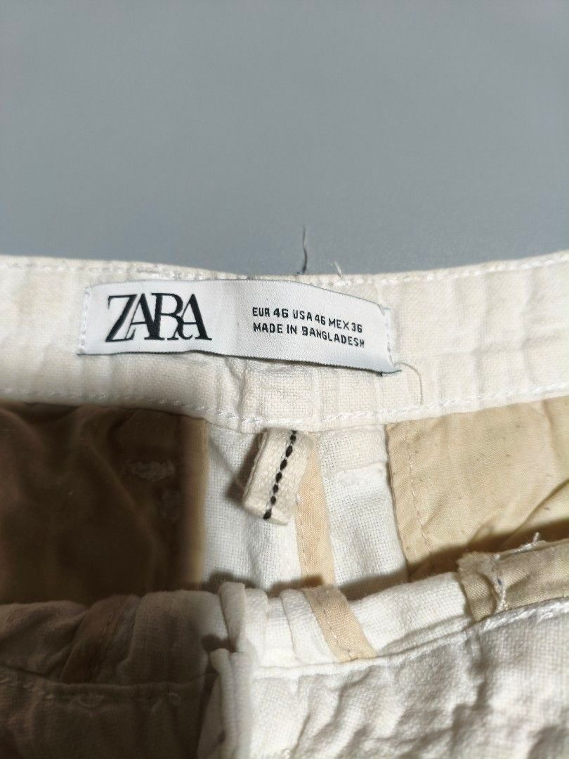 Zara White Shorts (Category: Shorts) located in Pasig City. Submitted by tobyrama (Listing ID 1470537758, Image 2). Description: White shorts from Zara. Features a button closure and pockets. The shorts are made in Bangladesh. The size is EUR 46, USA 46, MEX 36. The shorts have a classic design, suitable for casual wear. ✔️ Brand: Zara ✔️ Design: Beach Shorts ✔️ Color: White ✔️ Size: Waist 32 ✔️ Condition: Almost New ✔️ Dimensions: length: 18 inc