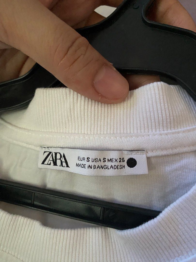 Zara White T-Shirt Size S (Category: Shirts) located in Manila. Submitted by love_mami (Listing ID 1470439583, Image 2). Description: - Condition: 9-10 needs wash since natambak sa cabinet for a long time - Brand: Zara - Color: Plain white - Size: EUR S / USA S / MEX 26 - Material: 100% cotton - Features: Short sleeves, classic crew neck with ribbed collar detailing.