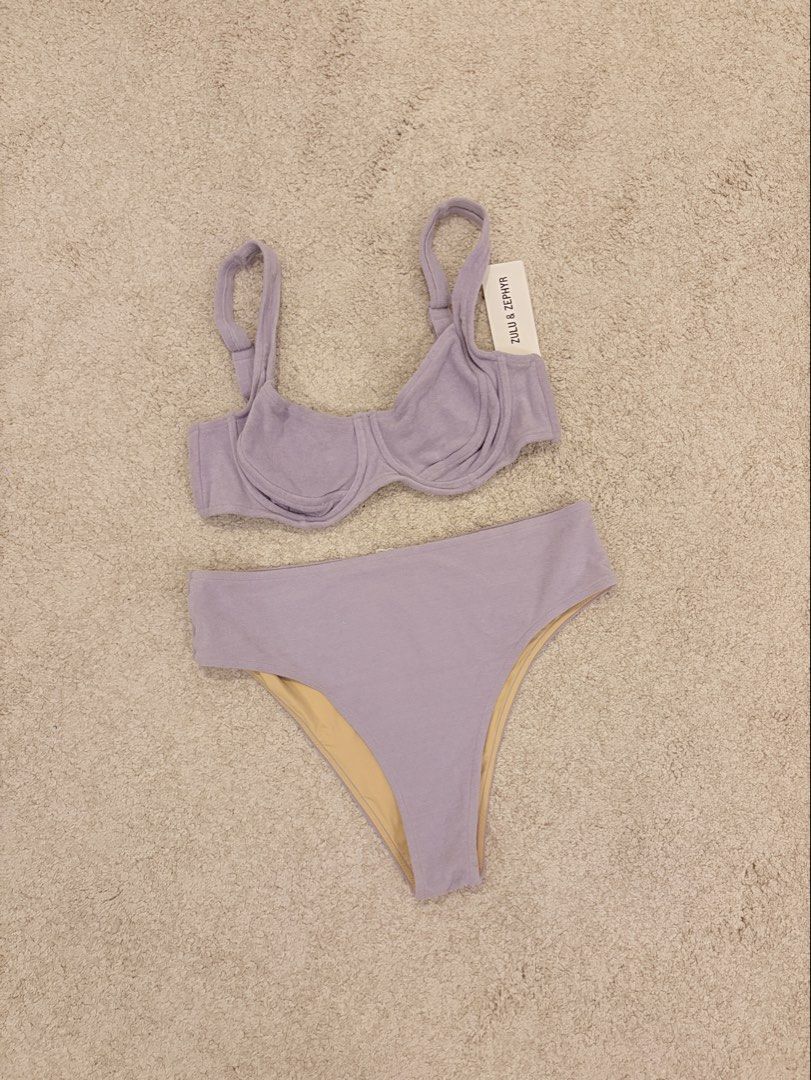 Zulu & Zephyr Purple Bikini Set (Category: Bikinis & Swimsuits) located in San Fernando. Submitted by precious.loved (Listing ID 1470420232, Image 1). Description: - Brand: Zulu & Zephyr - Condition: Brand new with tags attached - Color: purple shade with contrasting beige interior lining - Top: Underwire with adjustable straps - Bottoms: High-waisted style - Fully lined for comfort and quality Rfs: Wrong Size Delivery only through J&T .