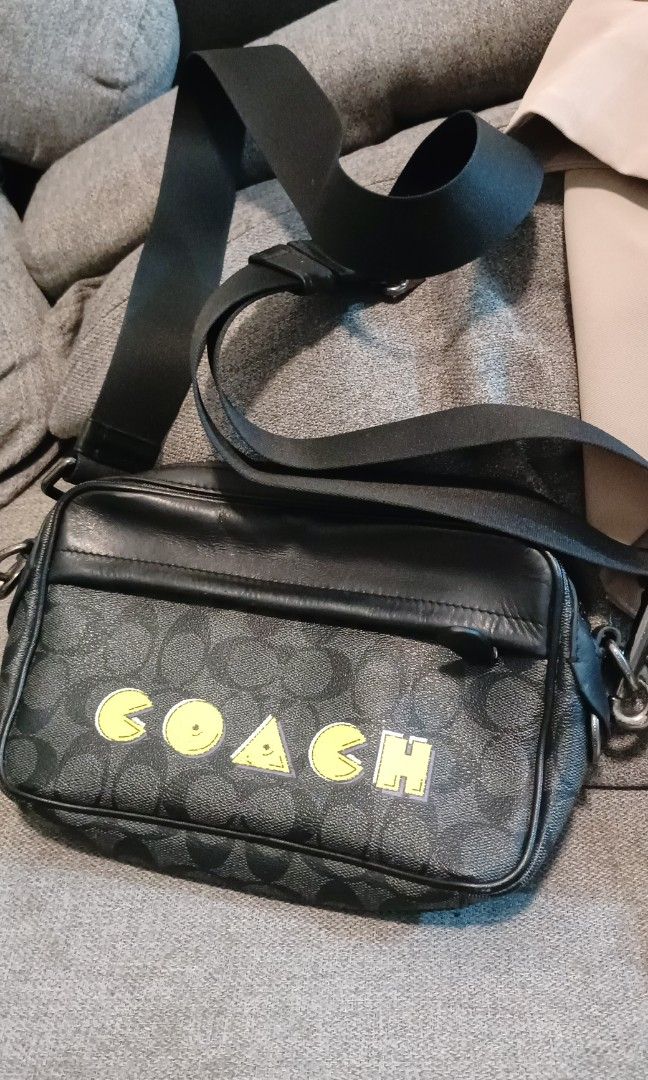 0riginal coach bag (Category: Cross-body Bags) located in Apalit. Submitted by missannefashionboutique (Listing ID 1470560219, Image 1). Description: Brand/Model: Coach Graham Crossbody / Camera Bag Design/Collaboration: Coach x PAC-MAN special edition featuring yellow letter graphics with Pac-Man characters integrated into the lettering Material: Signature coated canvas and refined calf leather trim in charcoal/black.