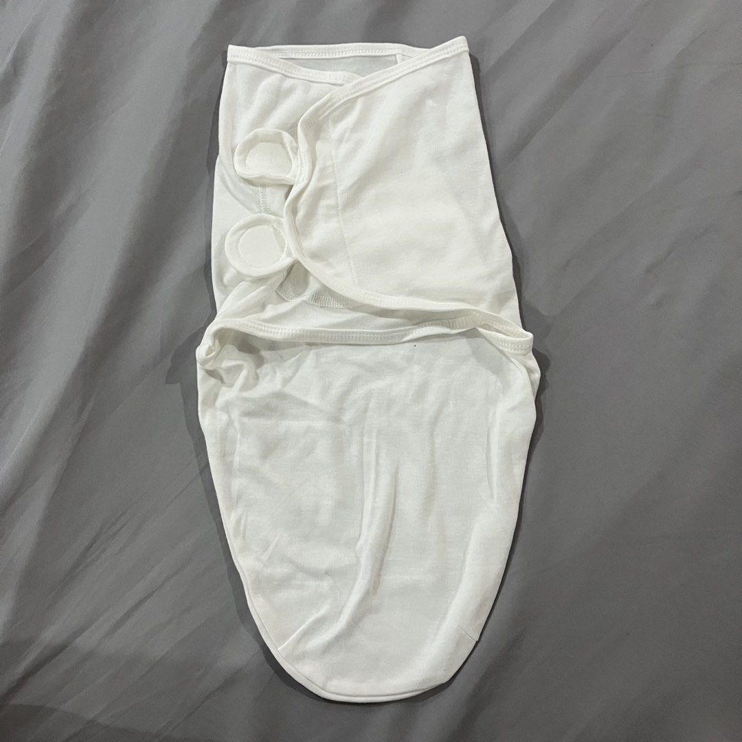 2 pcs. Baby Swaddle (Category: Babies & Kids Fashion) located in Makati City. Submitted by happycloset5 (Listing ID 1470614780, Image 2). Description: - Set of 2 newborn swaddles: 1 plain white and 1 grey with clouds and stars pattern - Soft and stretchy fabric keeps your baby comfortable - Secure Velcro tabs ensure a snug and cozy fit - Easy-to-use design for hassle-free sleep time wrapping.