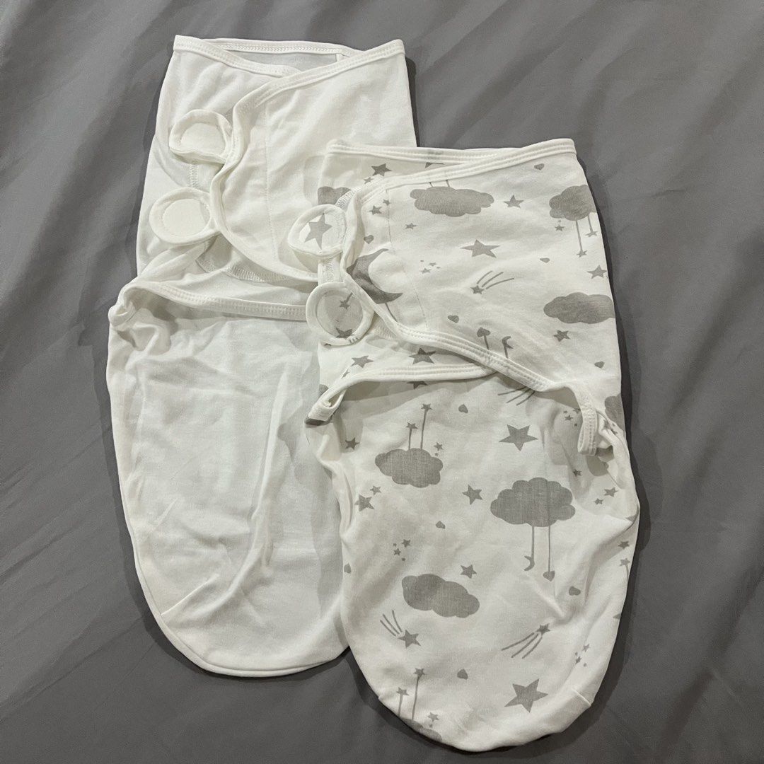 2 pcs. Baby Swaddle (Category: Babies & Kids Fashion) located in Makati City. Submitted by happycloset5 (Listing ID 1470614780, Image 1). Description: - Set of 2 newborn swaddles: 1 plain white and 1 grey with clouds and stars pattern - Soft and stretchy fabric keeps your baby comfortable - Secure Velcro tabs ensure a snug and cozy fit - Easy-to-use design for hassle-free sleep time wrapping.