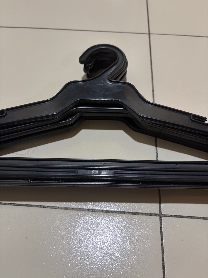 6 black plastic clothes hangers (Category: Hooks & Hangers) located in Muntinlupa City. Submitted by secondhandlove12345 (Listing ID 1470577550, Image 2). Description: - Color: Classic black - Material: Sturdy, durable plastic - Condition: Clean, excellent, no cracks or damage - Features: Shoulder notches and bottom bar hooks for straps and accessories - Size: Standard (ideal for shirts, pants, and daily wear) - Bundle: Sold as a whole set Pick u