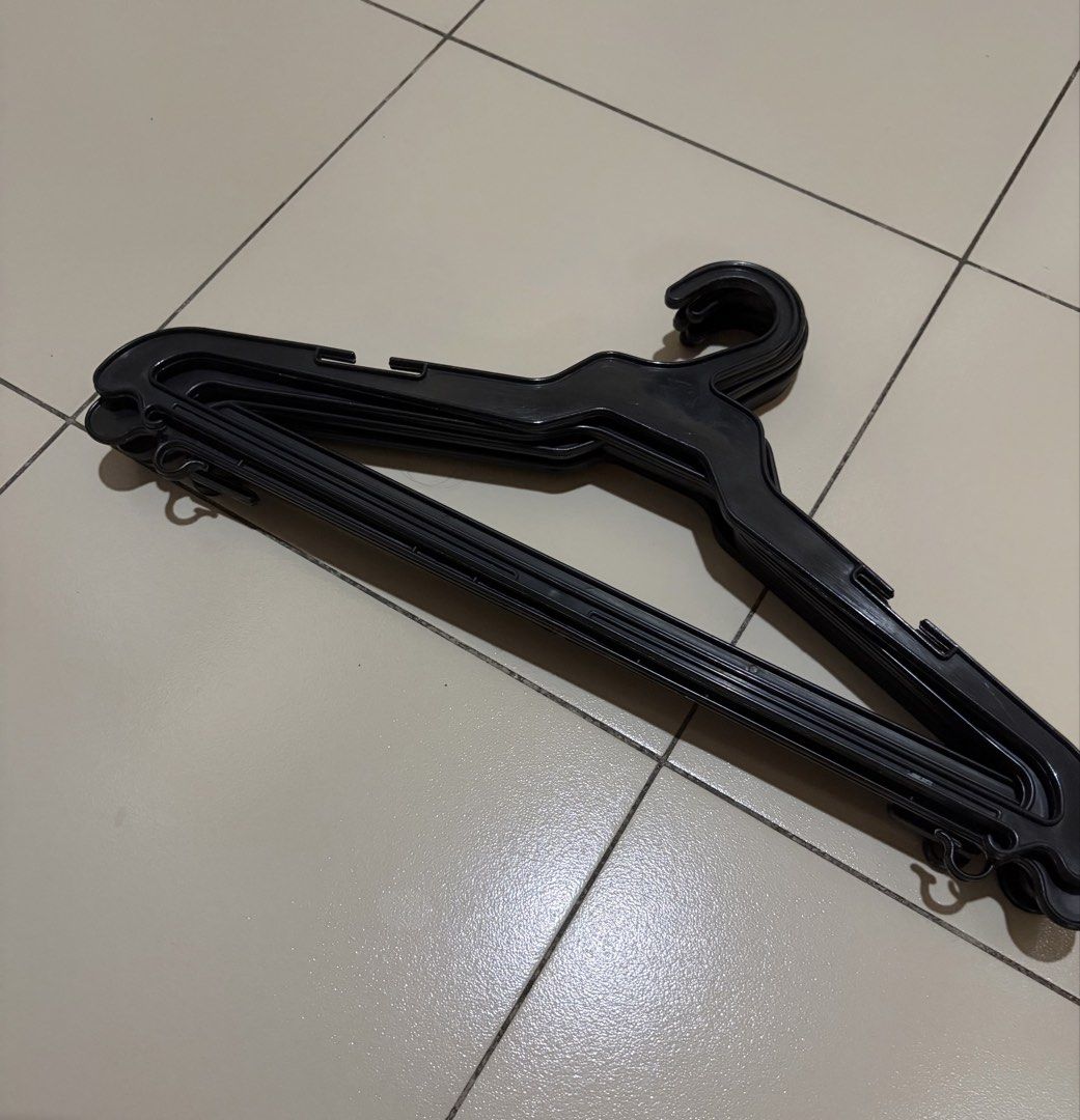 6 black plastic clothes hangers (Category: Hooks & Hangers) located in Muntinlupa City. Submitted by secondhandlove12345 (Listing ID 1470577550, Image 3). Description: - Color: Classic black - Material: Sturdy, durable plastic - Condition: Clean, excellent, no cracks or damage - Features: Shoulder notches and bottom bar hooks for straps and accessories - Size: Standard (ideal for shirts, pants, and daily wear) - Bundle: Sold as a whole set Pick u