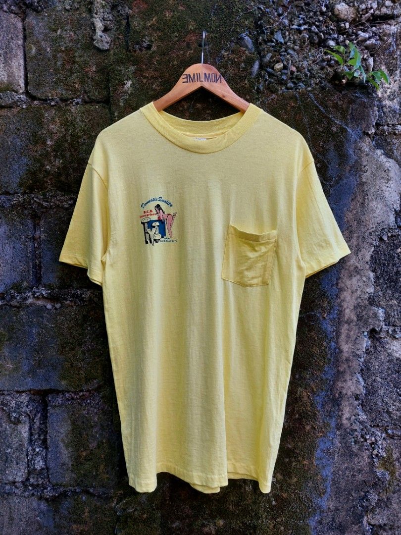 80's Promo Tee (Category: Tshirts & Polo Shirts ) located in Palayan City. Submitted by akhai420 (Listing ID 1470574640, Image 2). Description: - Brand/Style: Vintage 80's Hanes Beefy-T pocket tee - Design: D.C.B. Enterprises pinup graphics on front pocket and back - Material: Heavyweight 100% cotton, Made in U.S.A. - Era/Details: Classic single-stitch vintage tee - Size: L (42-44) - Condition: Good vintage feel, clean and vibrant color.
