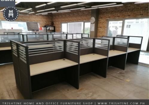 8-seater Workstation Fabric with Glass (Category: Office Furniture & Fixtures) located in Caloocan City. Submitted by jim.trishtineofficefurnitures (Listing ID 1470606004, Image 1). Description: - Type: Office cubicle workstations (interconnected row configuration) - Design: Clean, modern aesthetic with light woodgrain desktop and dark grey frames - Privacy: Built-in dividers and slatted privacy panels - Functionality: Includes cable management g