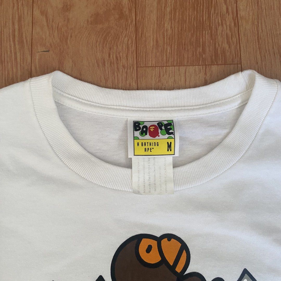 A Bathing Ape x Transformers White T-Shirt Size M (Category: Tshirts & Polo Shirts ) located in Manila. Submitted by 5treetw3ar (Listing ID 1470722942, Image 3). Description: - Brand: A Bathing Ape (BAPE) x Transformers - Color: White - Size: Medium (tag at collar intact) - Details: Features Optimus Prime, Bumblebee, and iconic Bape head logo with sleeve patch tag - Condition: Clean cotton fabric with vibrant chest print - Ideal for: Streetwear f