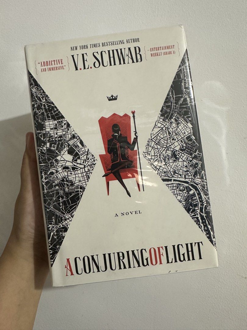 A Conjuring of Light by V.E. Schwab (Category: Storybooks) located in Batac City. Submitted by atlantis386 (Listing ID 1470557598, Image 1). Description: Hardcover copy of A Conjuring of Light by V.E. Schwab. Third book in the Shades of Magic series. Wrapped in a clear plastic protective cover. Pages clean, binding tight. Read once, stored carefully on shelf. Great addition to any fantasy collection..